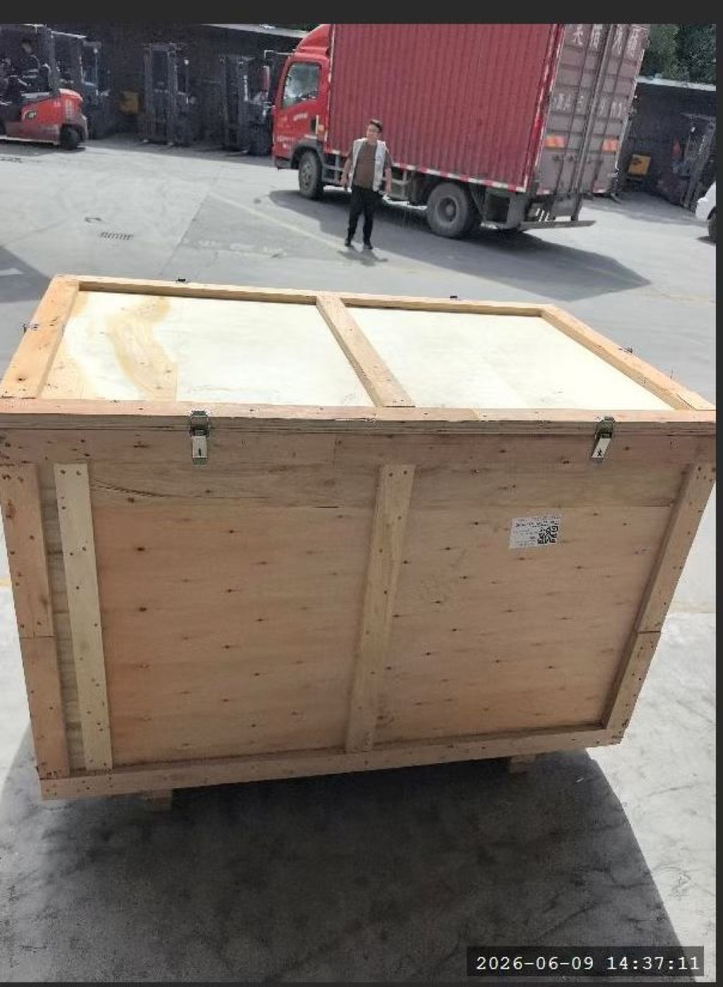 Large plywood export crate in a warehouse before collection