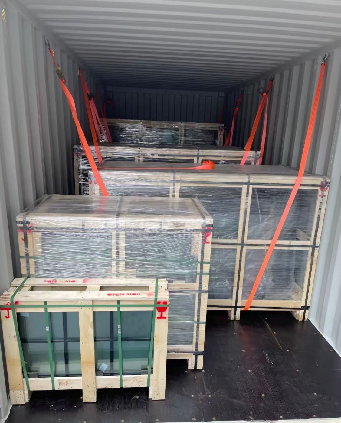 Crated cargo lashed with straps inside a shipping container